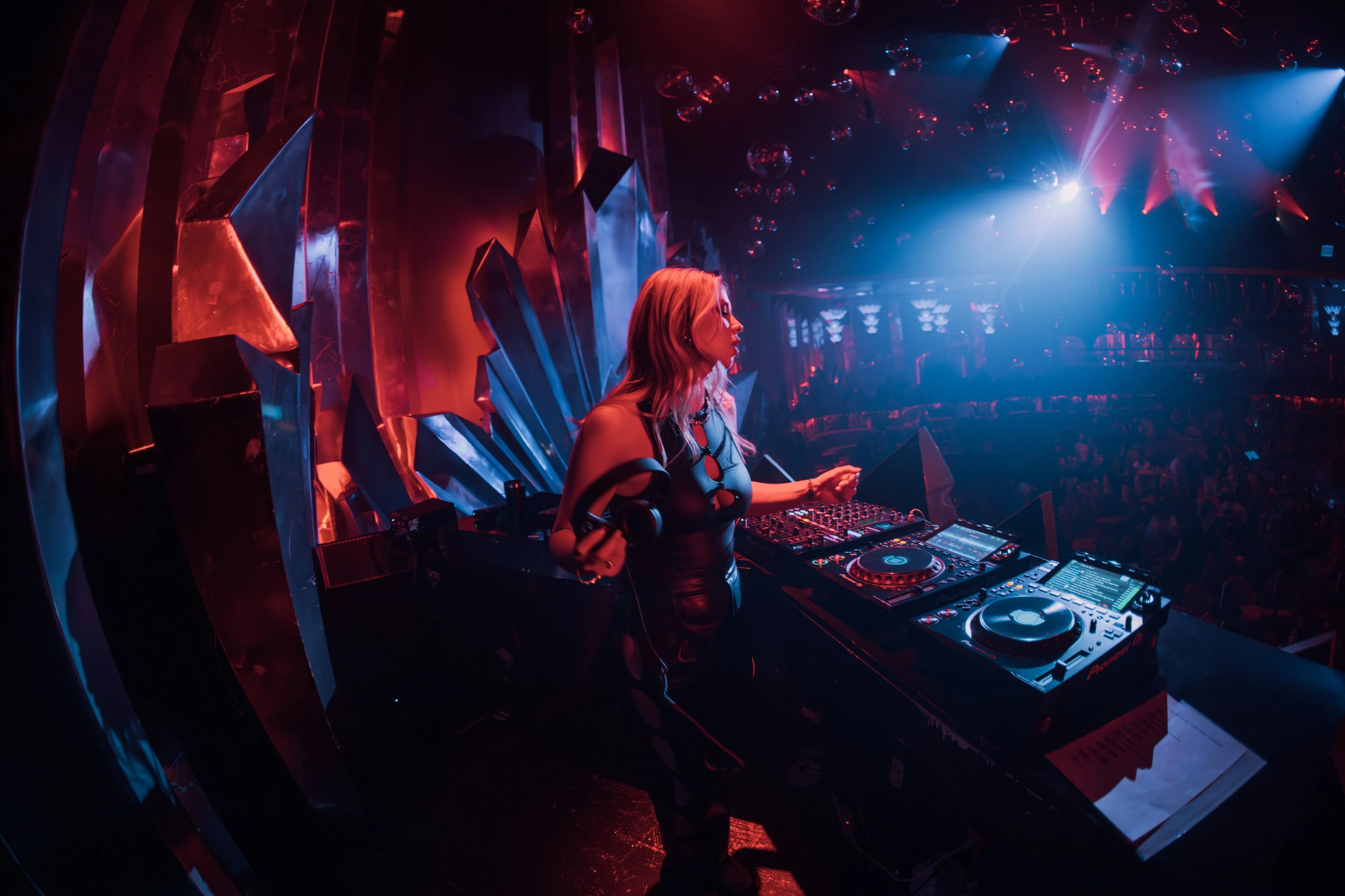 A DJ performing to a packed room at a Mainline show
